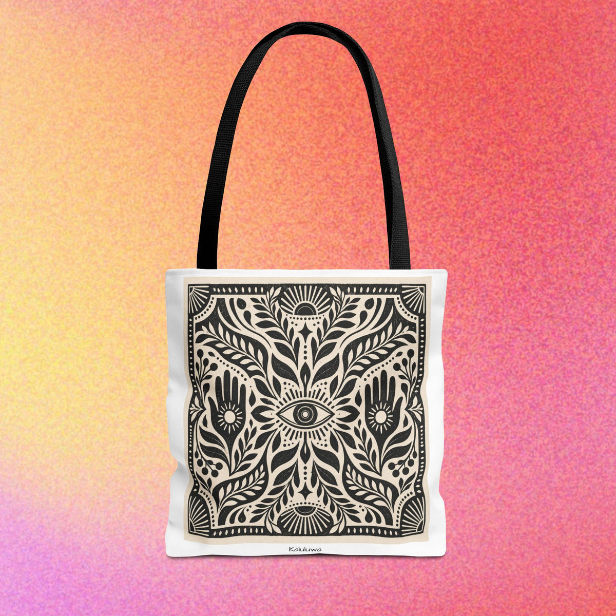All-over-print tote bag with mystical black-and-white Kaluluwa artwork and cotton webbing handles.