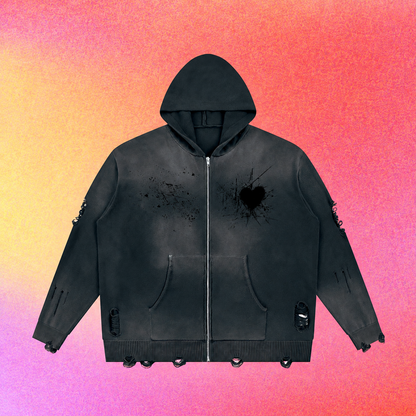 Close-up of the zipper area and distressed heart artwork on the hoodie.