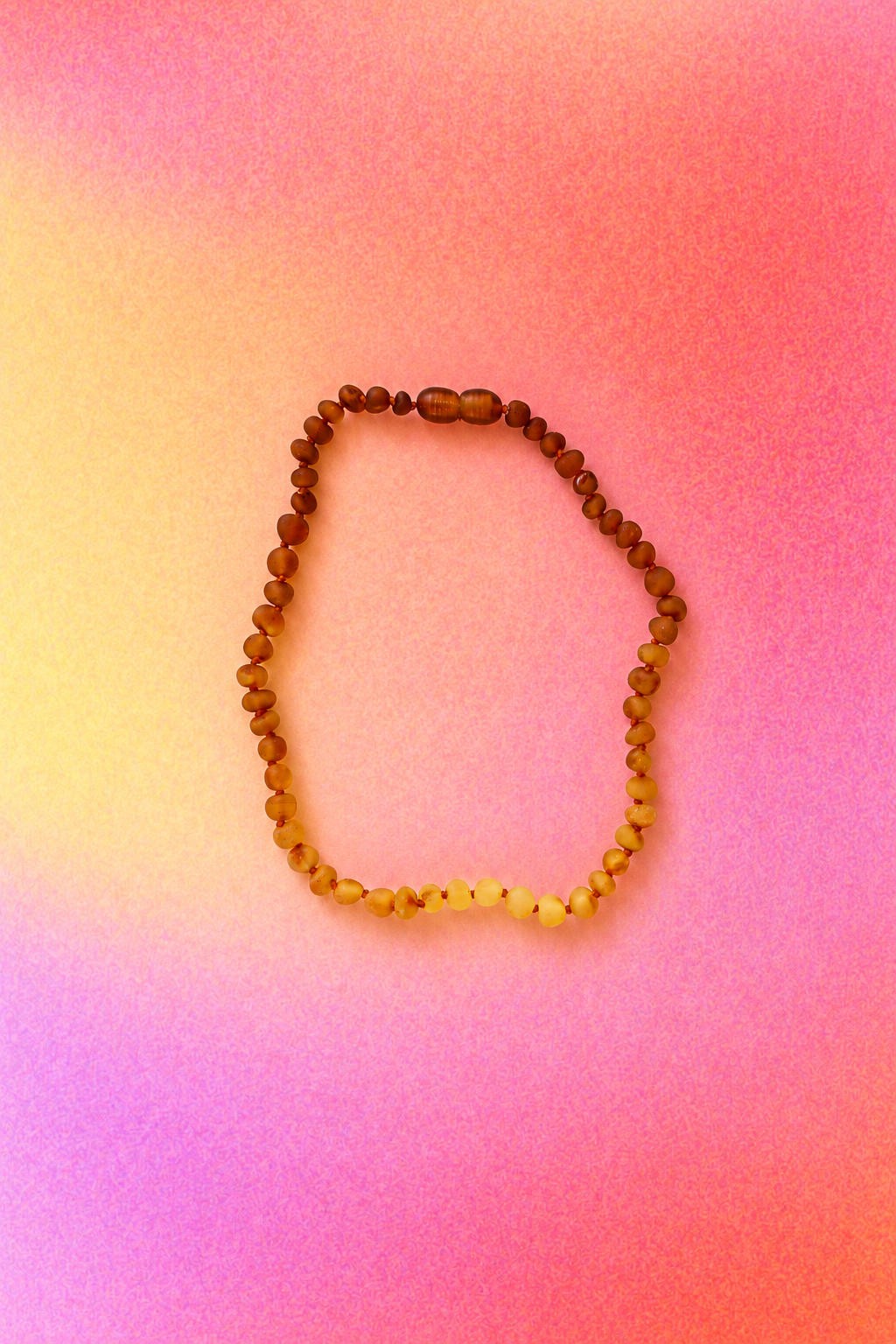 Handcrafted Baltic amber necklace with sunflower accent beads and knotted construction.